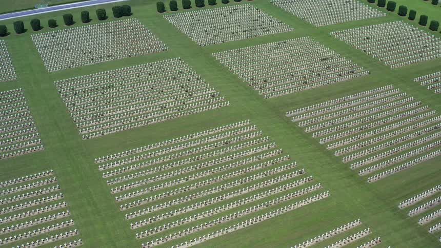 A cemetery with rows of crosses