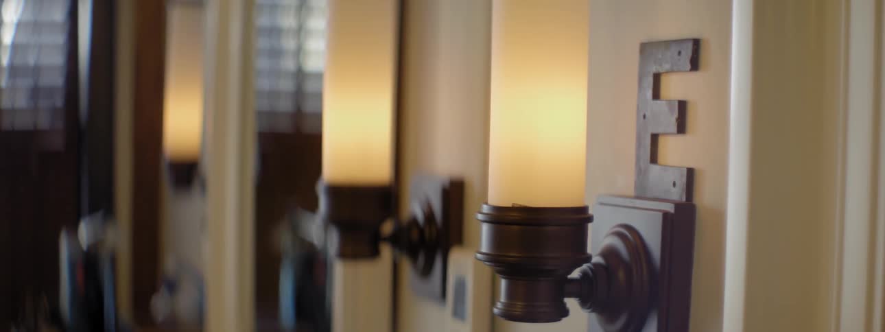 Letter e above a light fixture on a wall