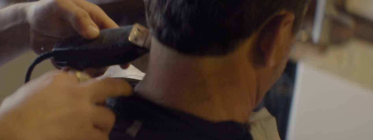 Close up of a trimmers shaving a man's head