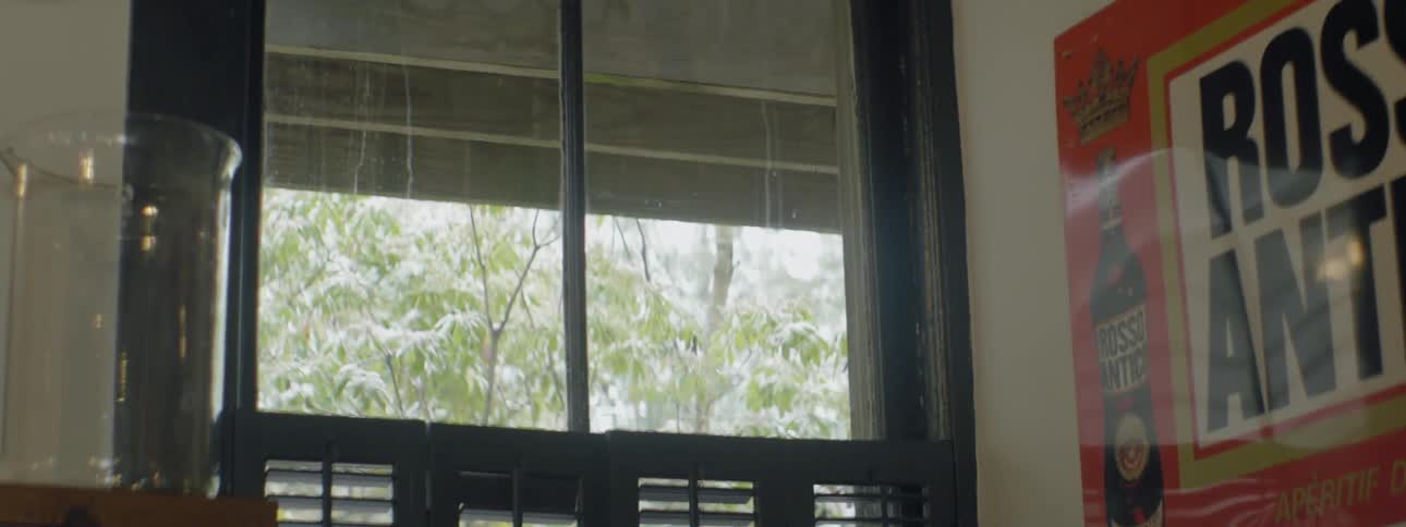 The glass is dirty and streaked above the shutters