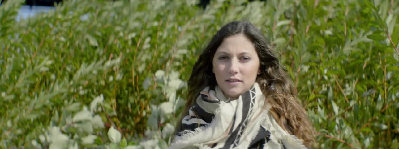 Scarves the woman standing in tall foliage