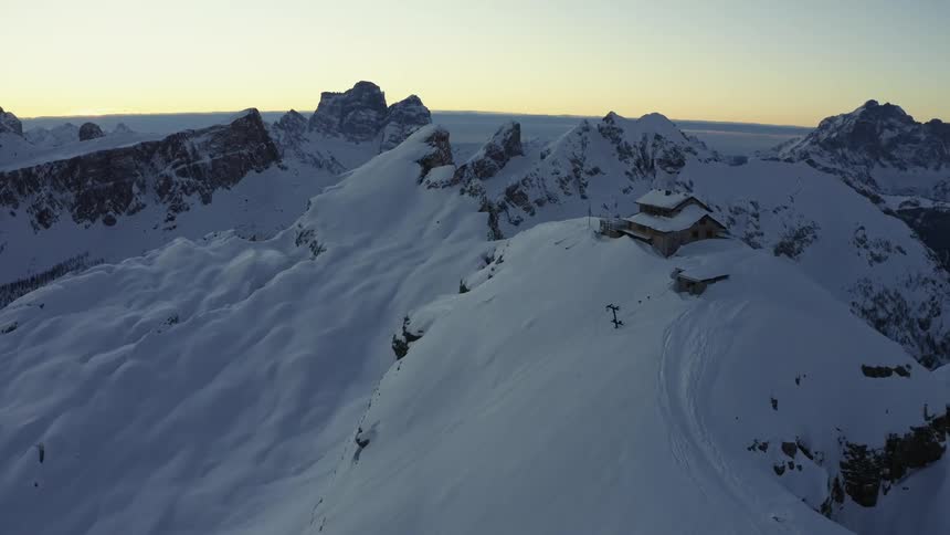 Buildings are on top of a very snowy mountain
