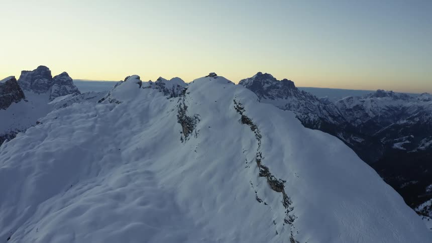 Snow covered mountains with peaks high in the sky