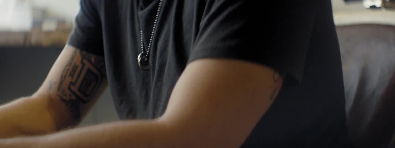 Rings worn on a chain are around a person's neck