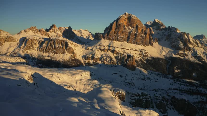 Snow is covering the mountains on a sunny day