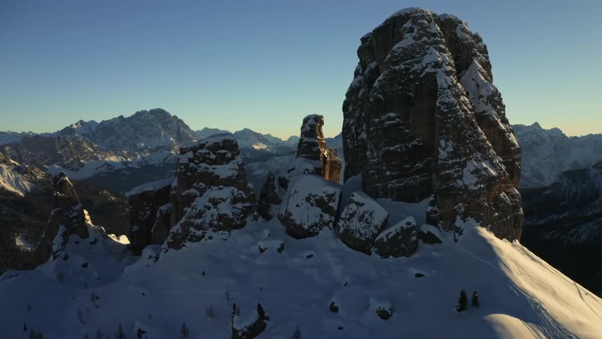 Heavy snow blankets the top of a mountain range