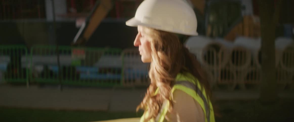 Woman walking with hard hat