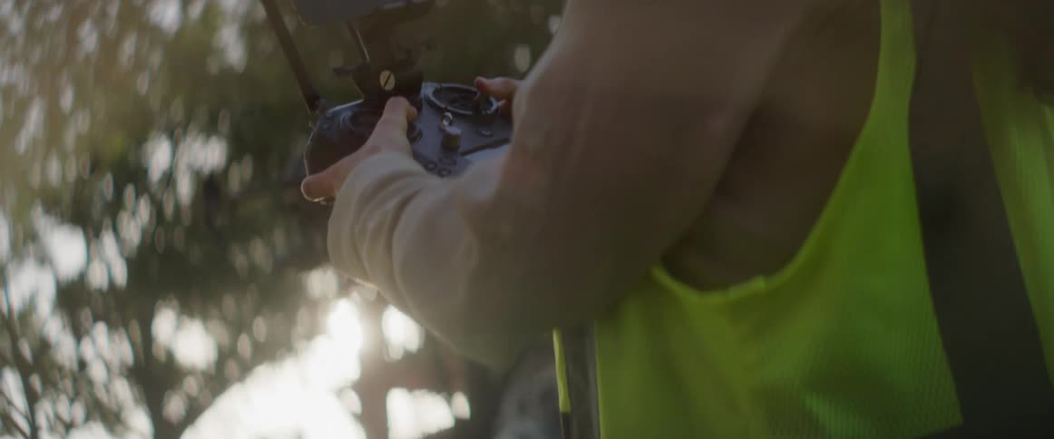 A person is flying a drone in the yard