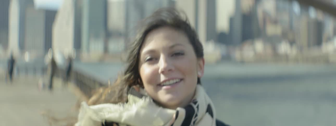 A woman is walking outside on a windy day