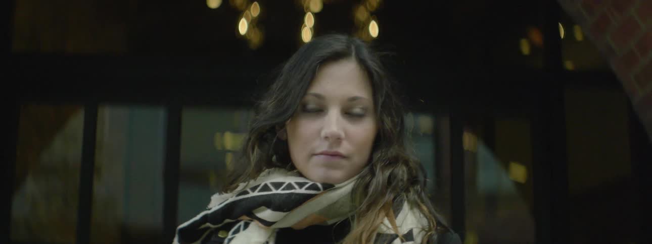 A woman slowly turns her head