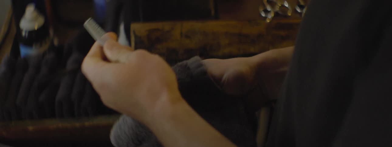 A man uses a towel to clean a comb