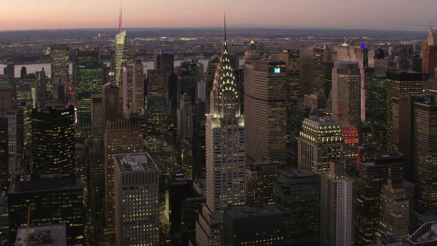 Aerial view of high rise office buildings in a downtown area with the shore and water in the distance