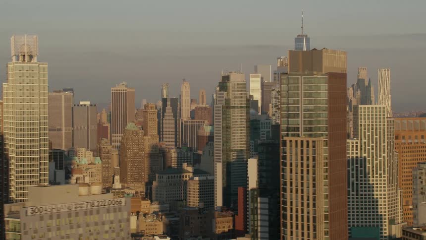 A city skyline with buildings and skyscrapers with the sky and clouds in the background