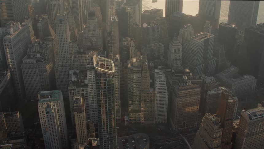Aerial view of tall office buldings in the city at dusk next to river