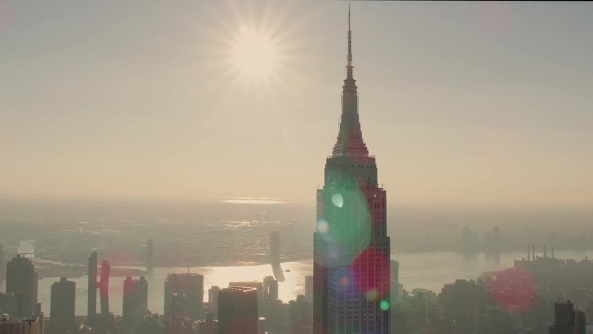 Aerial view of high rise buildings and city skyscrapers with spires at dawn