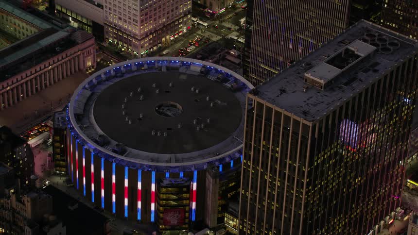 Aerial view of the colorful lights surrounding a stadium in the city