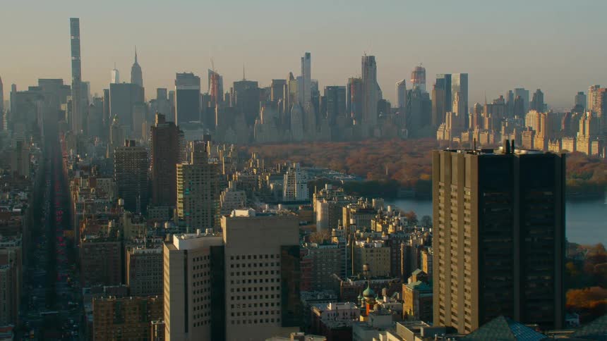 A city skyline with buildings and skyscrapers with the sky and clouds in the background