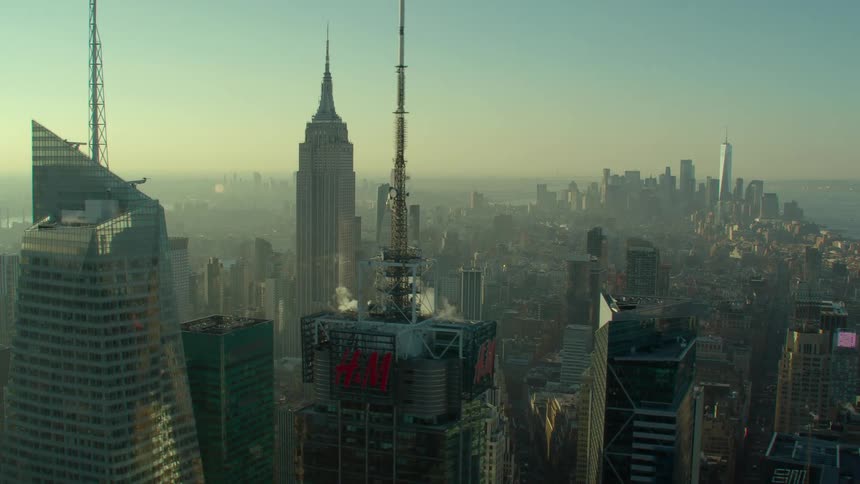 Aerial view of high rise buildings and city skyscrapers with spires at dawn