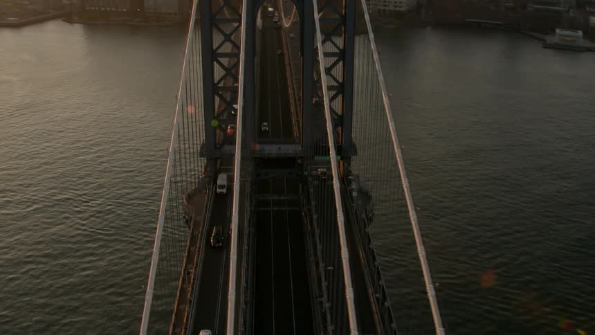 The long wire bridge leads to the city
