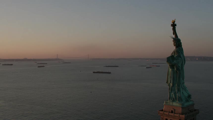 Aerial view of the statue of liberty in front of the new york city harbor