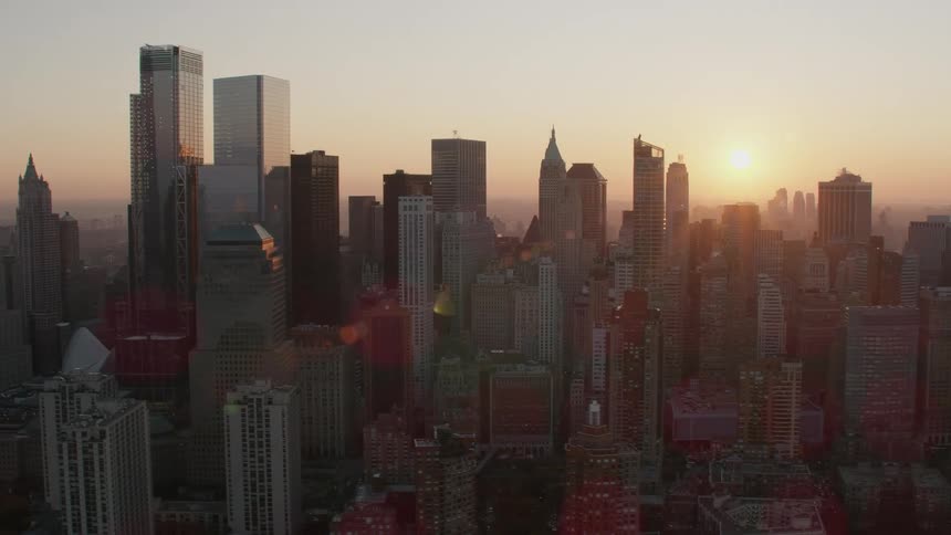 The sun is rising on the large city