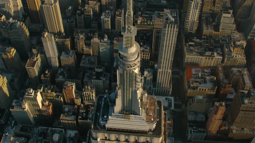 Metal architectural spire on skyscraper towers over surrounding skyscrapers in downtown