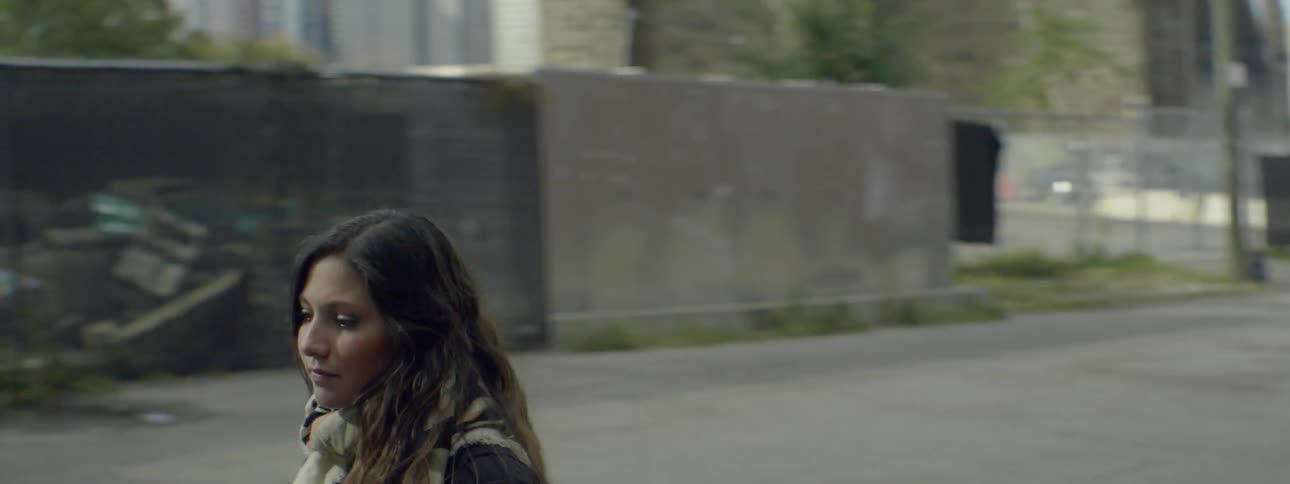 A woman walks down a city street