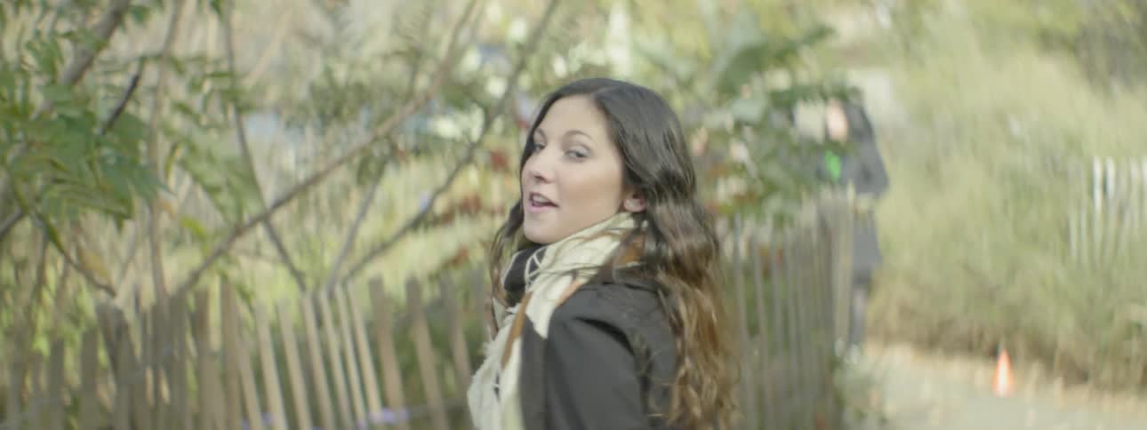 A woman walks along a trail and turns briefly
