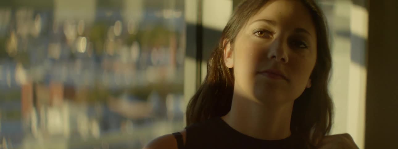 A woman is walking past a window