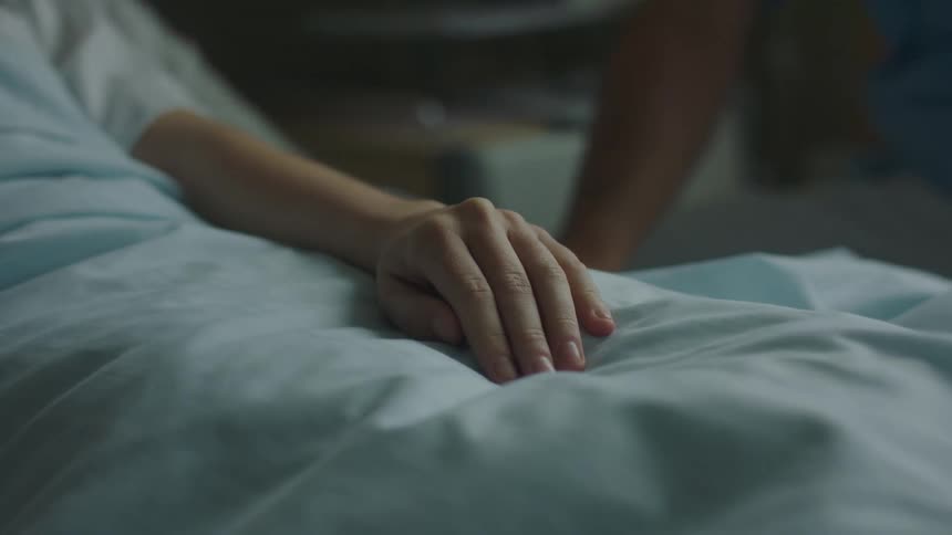 Compassionate Nurse Holding Patient’s Hand