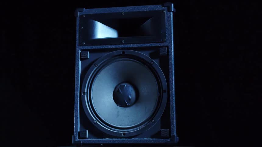 Speaker inside a dark room under flashing strobe lights