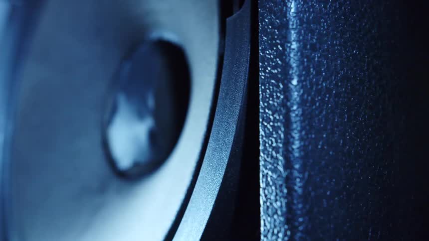A strobe light is flashing on an audio speaker