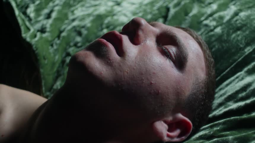 Man jerks while sleeping on green velvet covered cushion
