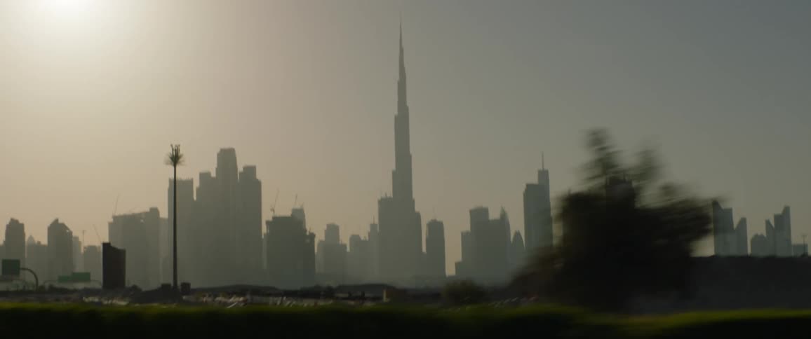 A city skyline with buildings and skyscrapers with the sky and clouds in the background