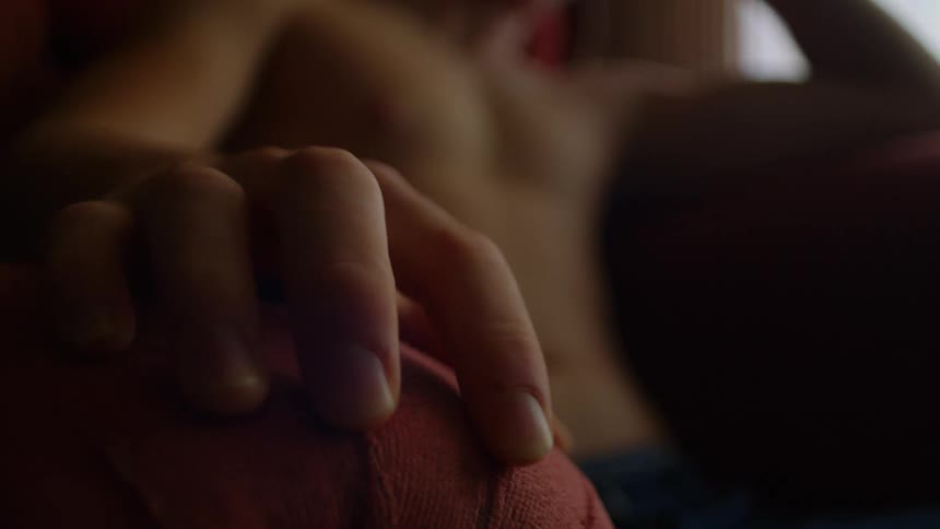 A person in a room sitting on a couch