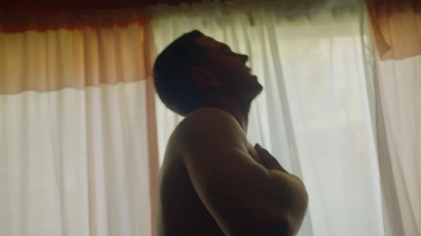 A man is holding his chest and convulsing