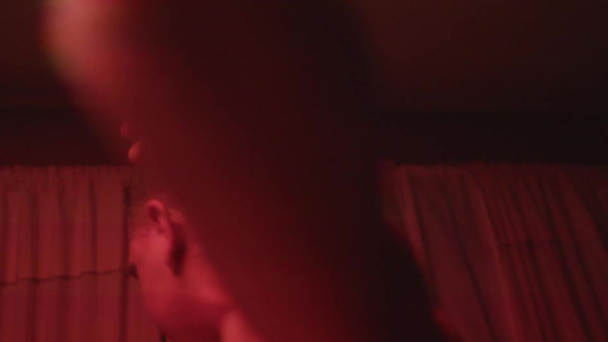 A man is swaying around the room with flashing lights