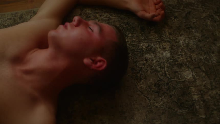 A man is passed out convulsing on the floor