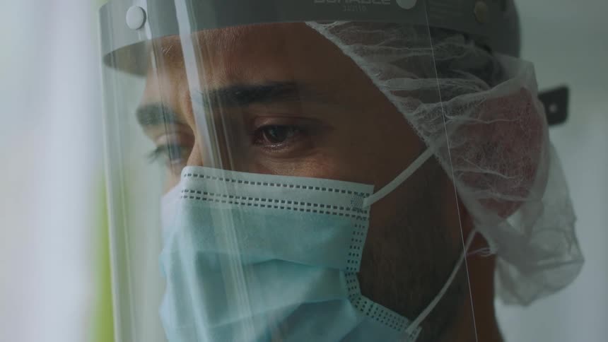 The man in the hospital is sad as he watches on