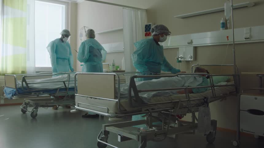 Hospital staff assist patients in the hospital room