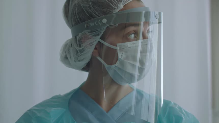 A doctor takes notes on a clipboard in the hospital