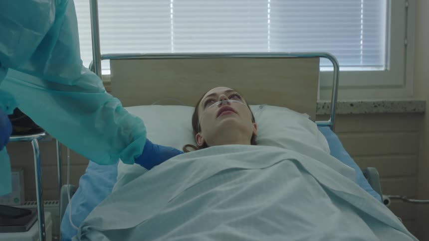 The doctor is touching the patients shoulder