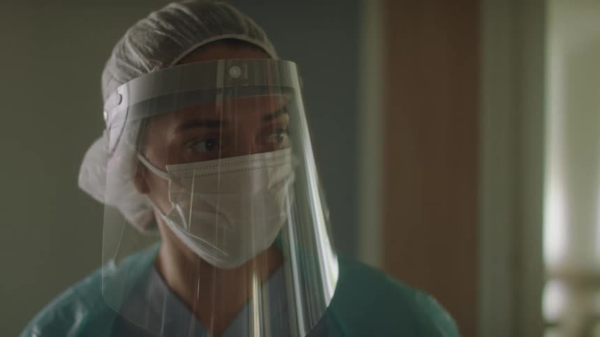 A doctor walking into a room with gear on