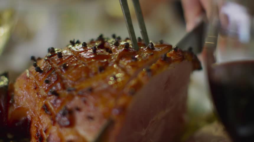 Person cutting ham