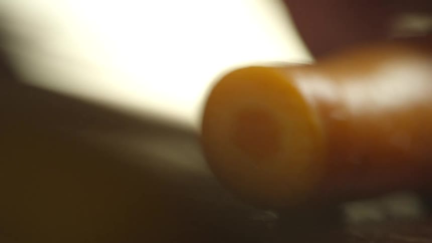 A close up of carrots being cut