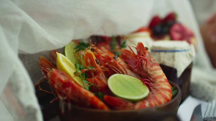Person removes cloth covering from shellfish and other food