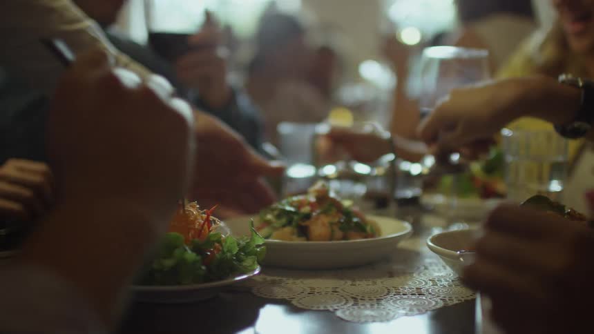 A group of people eating together at a restaurant