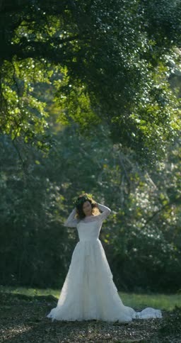 Bride standing outdoors in wedding dress