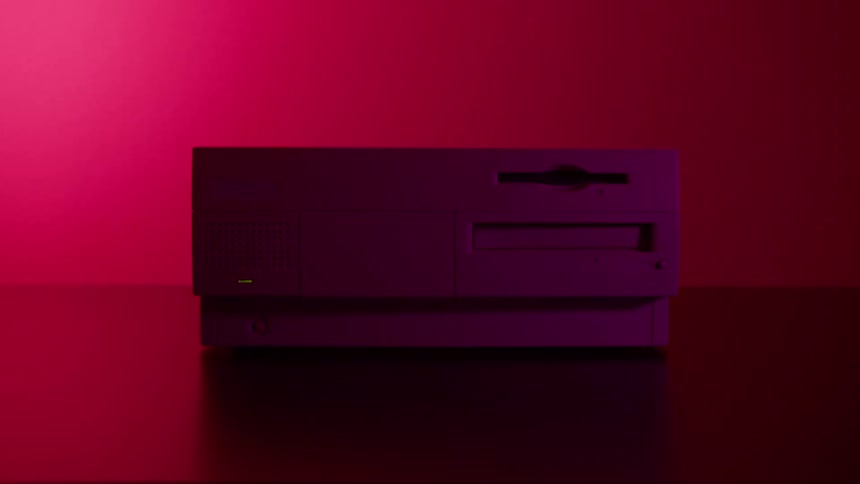 Vintage computer over a desk in front of flashing blue and red lights