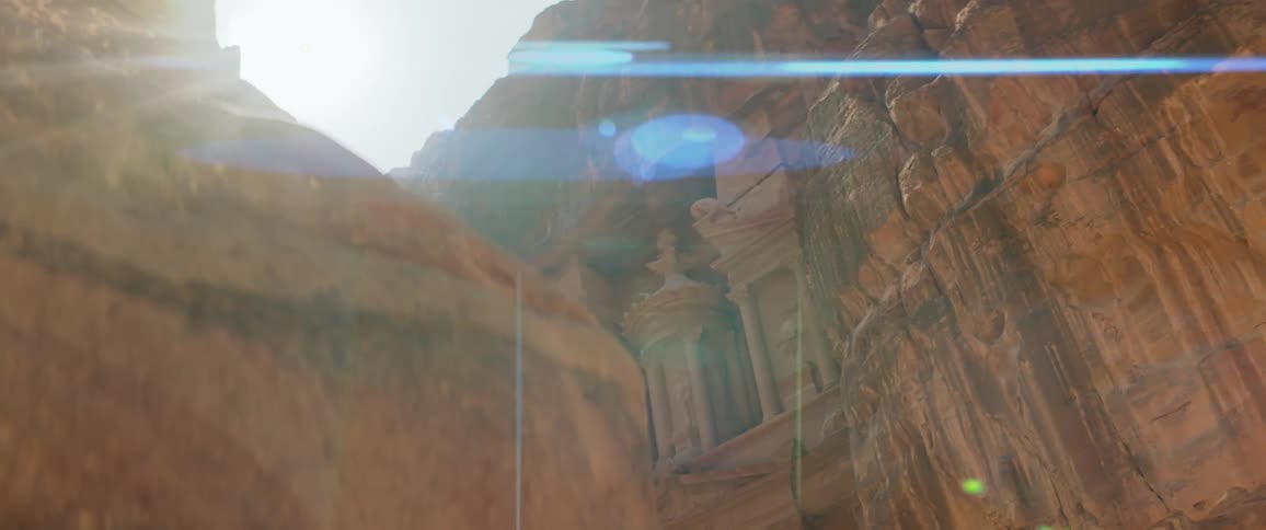 Column art is carved into the side of a canyon